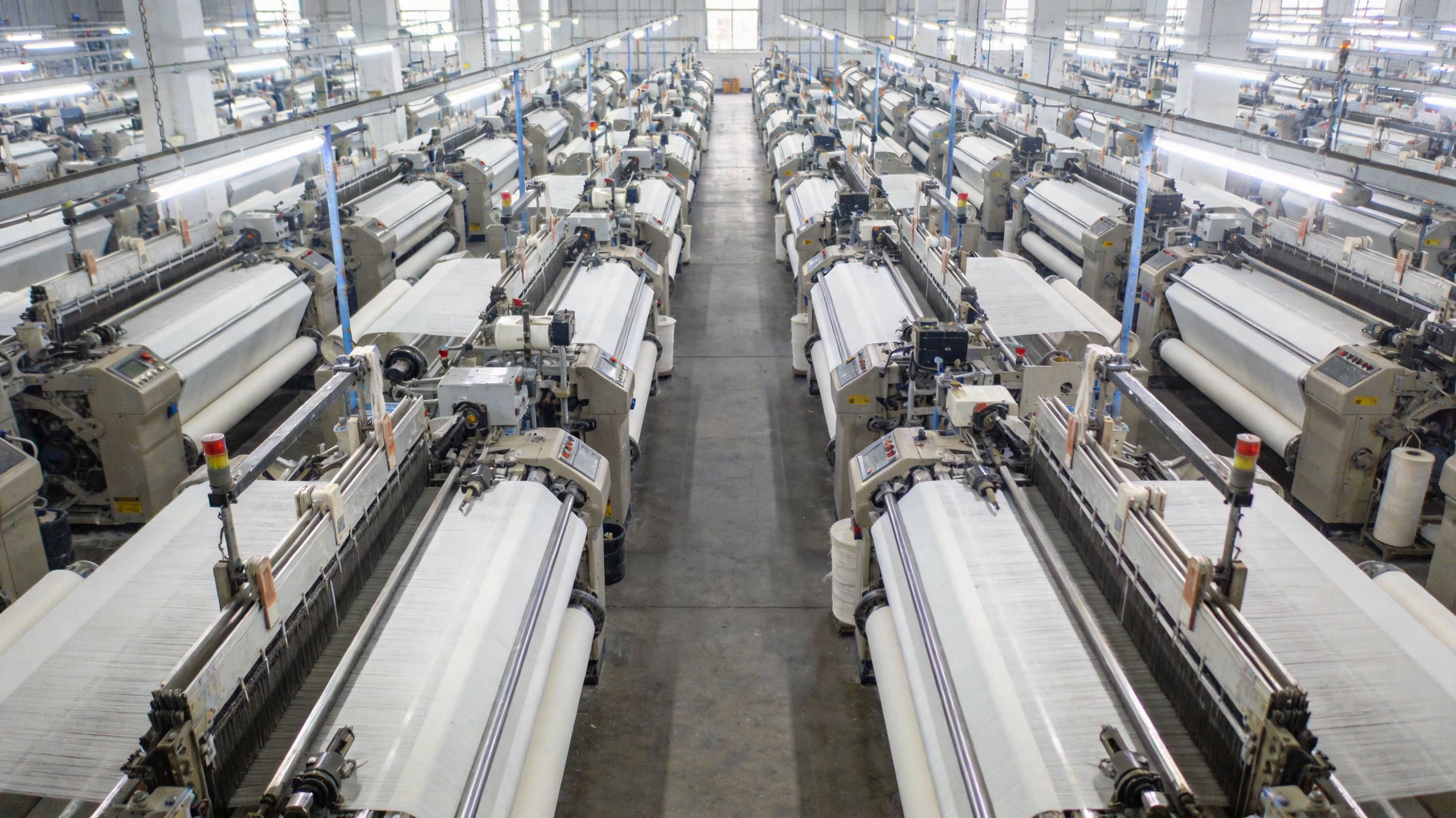 Modern textile factory floor with industrial weaving machines